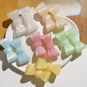 Pearlescent resin bow hair clips in multiple pastel colors for DIY sweet style