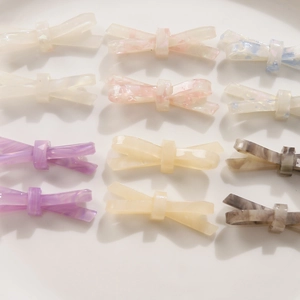 Vue à plat de barrettes à nœuds en acétate aux motifs marbrés variés et couleurs pastel