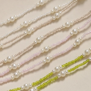 Detail of handmade pearl chain accessories with colorful seed beads for DIY shoe charms