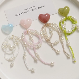 Detailed view of handmade beaded jewelry with colorful seed beads and faux pearls