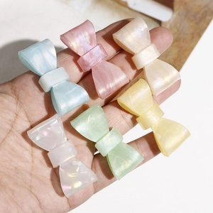 Iridescent marble bow hair clips in six pastel colors including blue and pink