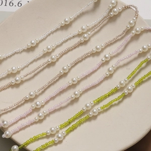 Detail of elegant pearl and colorful glass bead chains for DIY shoe accessories