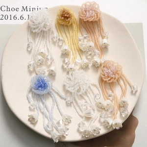 Macro view of handmade beaded lily of the valley flower tassels in six various colors