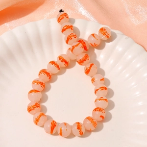 Detail of 13mm light pink lampwork beads with orange feather patterns for DIY jewelry