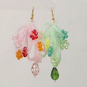 Detail view of colorful handmade beaded long drop earrings with vibrant crystal beads