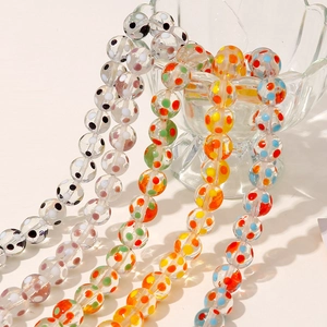 Macro detail of handmade rainbow polka dot glass beads for DIY jewelry and accessories