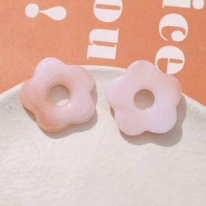 Close-up of pink gradient resin flower charms with center hole for DIY jewelry making