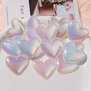 Macro shot of iridescent heart resin charms with pastel gradient for DIY phone cases