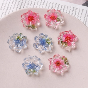 Detailed close-up of handmade resin flower charms for DIY jewelry and phone case crafts