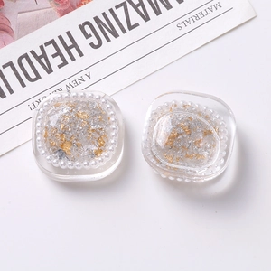Detail of square resin charms with gold foil flakes and pearl borders for DIY jewelry