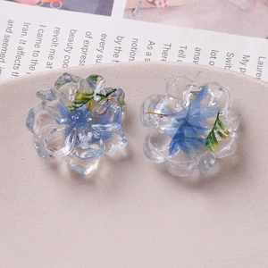 Transparent resin flower charms with embedded blue and green dried flowers for DIY jewelry