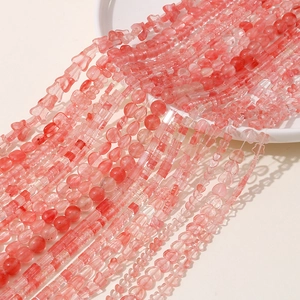 Macro detail of pink translucent crystal beads in heart and star shapes for jewelry making