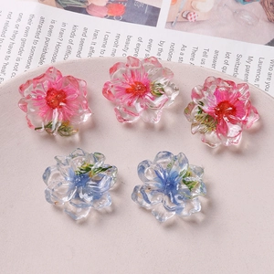 Detail of colorful resin floral charms with embedded dried flowers for DIY jewelry making