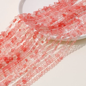 Macro shot of pink translucent DIY beads in heart, butterfly and geometric shapes