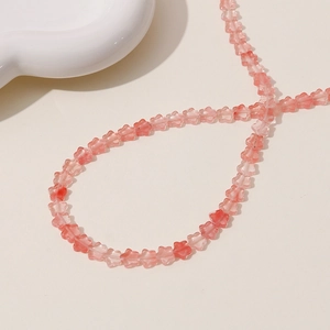 Detail shot of pale pink translucent five-petal flower beads for jewelry making