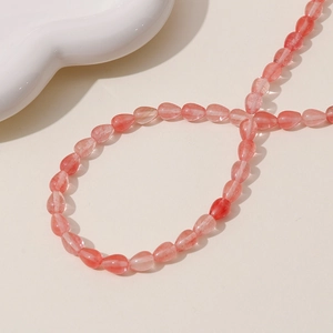 Macro view of polished translucent pink pear-shaped quartz beads with natural textures