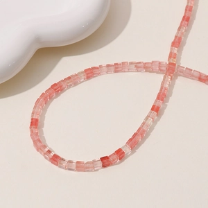 Macro shot of pink strawberry crystal square beads for DIY jewelry making