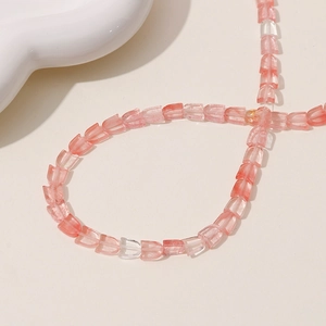 Detailed view of pink and clear tulip-shaped beads for DIY jewelry making and crafts