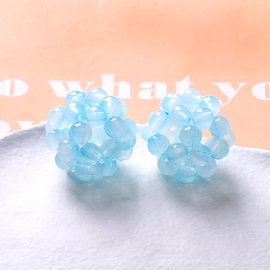 Macro shot of hand-woven 32mm light blue gradient acrylic hollow ball beads for DIY jewelry