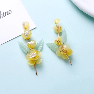 Detailed handmade flower hairpiece with yellow petals, green leaves and gold wirework