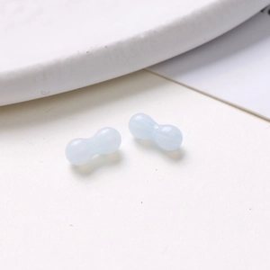 Macro detail of 8mm light blue peanut-shaped glass beads for DIY jewelry making
