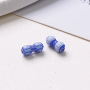 Macro shot of 8mm peanut-shaped glass beads with blue and white porcelain pattern