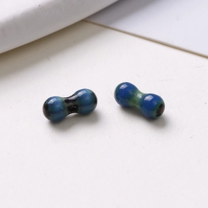 Detailed macro of 8mm blue-green gradient peanut-shaped glass beads for DIY jewelry