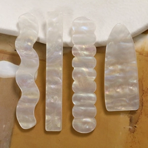 Detailansicht irisierender weißer Acryl-Wellenanhänger für DIY-Haarspangen und Schmuck