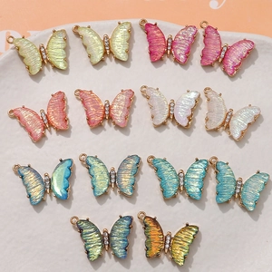 Macro detail of 14 colorful butterfly pendants with gold alloy and sparkling zircon