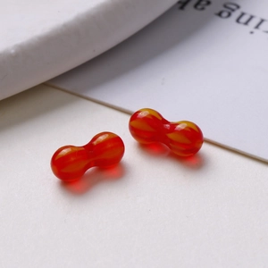 Macro shot of two 8mm red and yellow marbled glass beads for handmade jewelry DIY