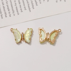 Macro shot of 3D butterfly pendants with pearlescent finish and mini rhinestone centers