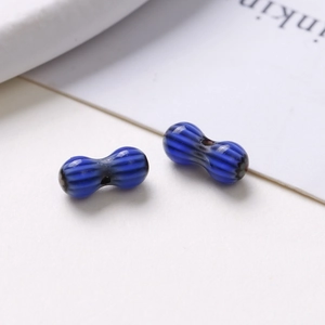 Close-up of 8mm blue striped oval glass beads for DIY jewelry making and handmade crafts