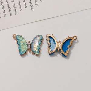 Macro shot of colorful gradient butterfly pendant with gold plating and zircons