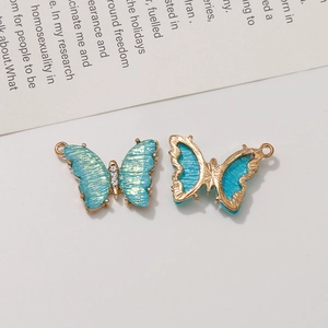 Detailed view of dual-sided gradient blue butterfly pendant with white rhinestones