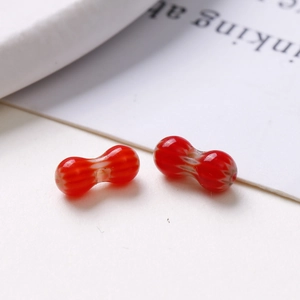 Close-up of 8mm red and white striped oval glass beads for DIY jewelry making