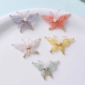 Handmade beaded butterfly charms with pearls and gold accents in multiple colors