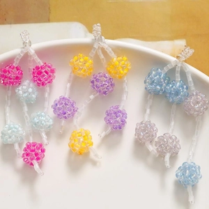 Detailed view of colorful handcrafted beaded balls for DIY jewelry and hair accessories