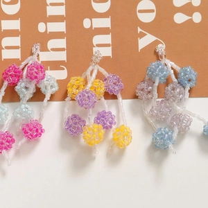 Detailed close-up of handmade beaded colorful fruit ball tassels for DIY jewelry making