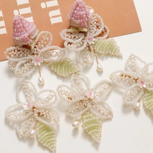 Handmade beaded flower hair clips with pearl drops in pink, white, and green tones