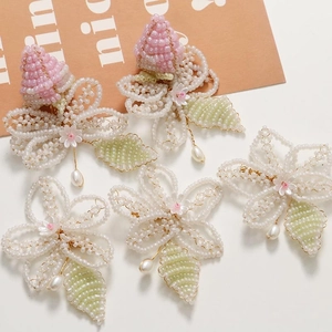 Detailed handmade beaded floral accessory with pink buds and pearl pendant detail