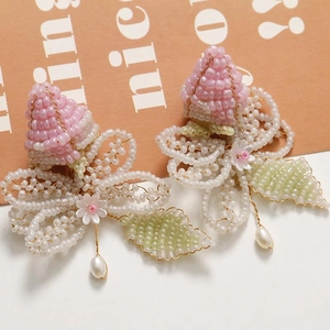 Handcrafted floral beaded earrings with pink petals, green leaves and drop pearls