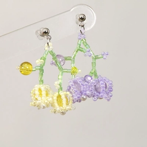 Handmade colorful beaded flower earrings with pastel green and purple floral pattern