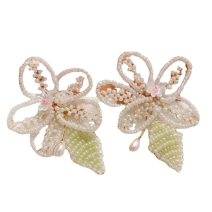 Handmade beaded floral hair clips with green leaf accents and white teardrop pearls