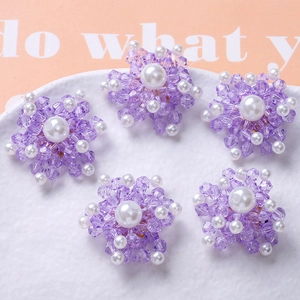 Detailed view of handmade purple crystal flower beads with white faux pearls