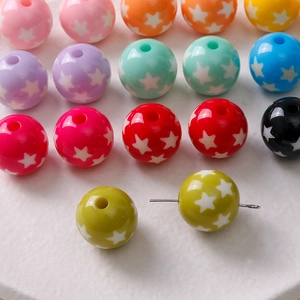 Macro detail of 16mm colorful star pattern resin beads with central hole for DIY jewelry