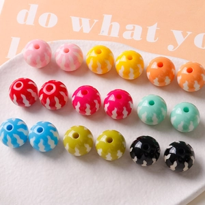 Detailed view of colorful 16mm pumpkin acrylic beads with wave pattern for DIY jewelry