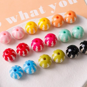 Close-up of 16mm colorful pumpkin resin beads with white wave patterns for DIY jewelry making
