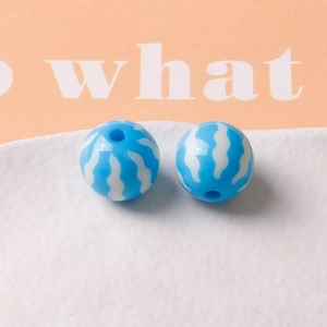 Close-up of 16mm blue pumpkin resin beads with white wavy stripes for DIY jewelry making