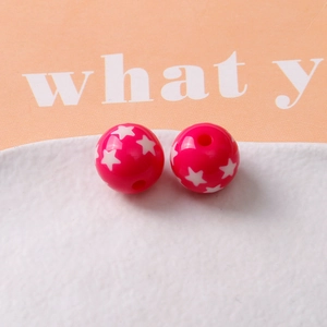 Detailed view of magenta star pattern resin beads for DIY jewelry and bracelets