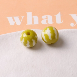 Close-up of olive green 16mm pumpkin resin beads with white wavy stripes for DIY jewelry